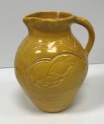 A Susie Cooper jug with leaping ram decoration inscribed "Susie Cooper England" to base 22 cm high