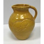 A Susie Cooper jug with leaping ram decoration inscribed "Susie Cooper England" to base 22 cm high