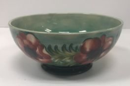 A Moorcroft bowl with poppy decoration raised on circular pedestal base 9.