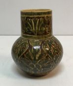 A Maw & Co Ltd Jackfield vase with stylised foliate decoration on a brown/maroon ground inscribed