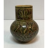 A Maw & Co Ltd Jackfield vase with stylised foliate decoration on a brown/maroon ground inscribed