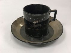 A Wedgwood coffee can and saucer decorated by Alfred Powell No'd 4353 to base,