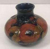 A Moorcroft pomegranate design squat baluster vase 10.