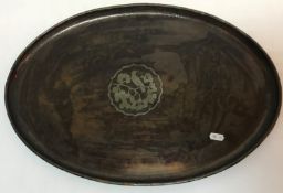 A Hugh Wallis copper tray of oval form with bird on branch decoration to centre and stamped "WH",