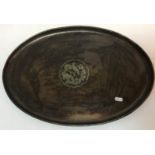 A Hugh Wallis copper tray of oval form with bird on branch decoration to centre and stamped "WH",