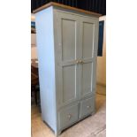 A modern duck egg blue painted Shaker style kitchen cupboard with two doors enclosing a fitted