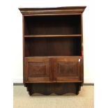 A mahogany wall cabinet with two open shelves over two fielded panel doors 67 cm wide x 27 cm deep