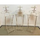 A set of five cream painted metal folding suit stands 46 cm wide x 115 cm high and four various