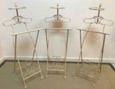 A set of five cream painted metal folding suit stands 46 cm wide x 115 cm high and four various