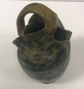 A R W Martin vase of collapsed form with mottled green,