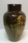 A large Torquay Pottery type vase/stick stand with floral decoration on a green and brown ground 56