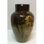 A large Torquay Pottery type vase/stick stand with floral decoration on a green and brown ground 56