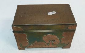 An Arts & Crafts hinge lidded box/casket with copper and brass decoration depicting buildings in a