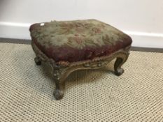 A Victorian carved giltwood and gesso framed footstool with aubusson style floral tapestry seat on