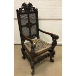 A late Victorian carved oak throne style hall chair in the 17th Century Flemish manner,