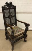 A late Victorian carved oak throne style hall chair in the 17th Century Flemish manner,