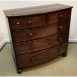 A Victorian mahogany bow fronted chest of two short over three long graduated drawers on turned