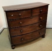 A Victorian mahogany bow fronted chest of two short over three long graduated drawers on turned