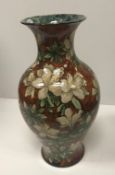A Royal Doulton faience ware baluster shaped vase with all-over floral design,