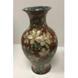 A Royal Doulton faience ware baluster shaped vase with all-over floral design,