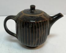 A David Leach treacle glazed teapot with cut sided design 16.