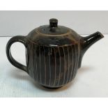 A David Leach treacle glazed teapot with cut sided design 16.