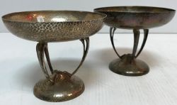 A pair of Edwardian silver hammered pedestal bowls on tri-form bases to a circular foot (by Lawson