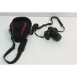 A Panasonic Lumix DMC-G2 camera with a 14-42 lens, instructions,