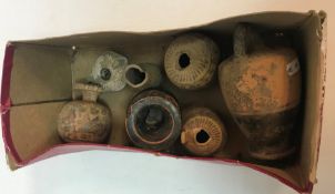 A box containing assorted Roman/Etruscan pottery vessels to include an oil lamp etc the tallest