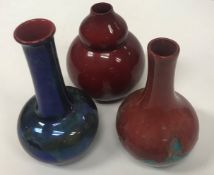 A collection of three Bernard Moore vases comprising one flambé red gourd shaped vase 12.