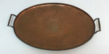 An Arts & Crafts style copper twin-handled tray of oval form,