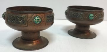 A pair of Arts & Crafts enamelled and beaten copper pedestal bowls by Harry C Hall,