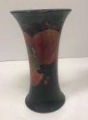 A Moorcroft pomegranate trumpet shaped vase stamped "Moorcroft Burslem England" and signed "W