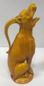 A Burmantofts yellow glazed jug as “Seated howling beast”,