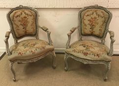 A 19th Century carved giltwood and gesso framed three piece salon suite of two seat sofa and pair