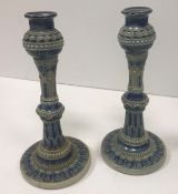 A pair of Martin Brothers incised blue glazed pottery candlesticks,