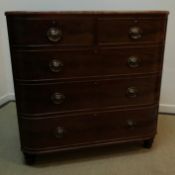 A Victorian mahogany bow fronted chest of two short over three long graduated drawers on turned