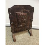 A Newlyn Arts & Crafts copper fire screen depicting Viking style longboats,