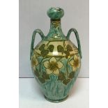 A Della Robbia twin handled vase decorated by Ruth Bare with foliate and flower decoration circa