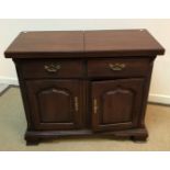 A modern mahogany sideboard / dresser with folding top over two dummy drawers and two cupboard