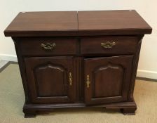 A modern mahogany sideboard / dresser with folding top over two dummy drawers and two cupboard
