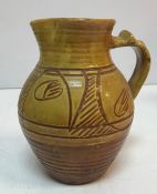 A Ray Finch Winchcombe Pottery brown and ochre glazed jug with incised decoration,