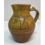 A Ray Finch Winchcombe Pottery brown and ochre glazed jug with incised decoration,