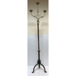 A late 19th Century brass floor-standing three branch candelabra with twisted supports,