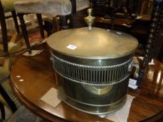 An oval brass coal box in the Regency taste, mahogany bar back carver chair,