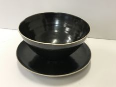 A Lucie Rie and Hans Coper black glazed elliptical bowl and saucer, the bowl bears no maker's marks,