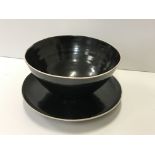 A Lucie Rie and Hans Coper black glazed elliptical bowl and saucer, the bowl bears no maker's marks,