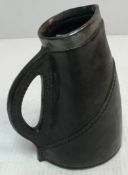 A Royal Doulton Lambeth blackjack jug with silver rim,