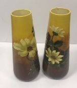 A pair of Burmantofts faience conical vases with floral decoration No'd 1559 to base 31 cm high