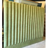 A large green ribbed cloth upholstered headboard, 220 cm x 185 cm,